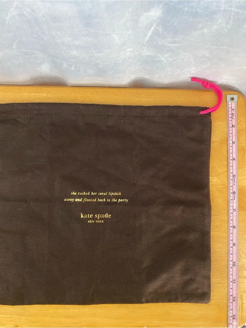 kate spade brown dust bag with pink drawcord and gold logo